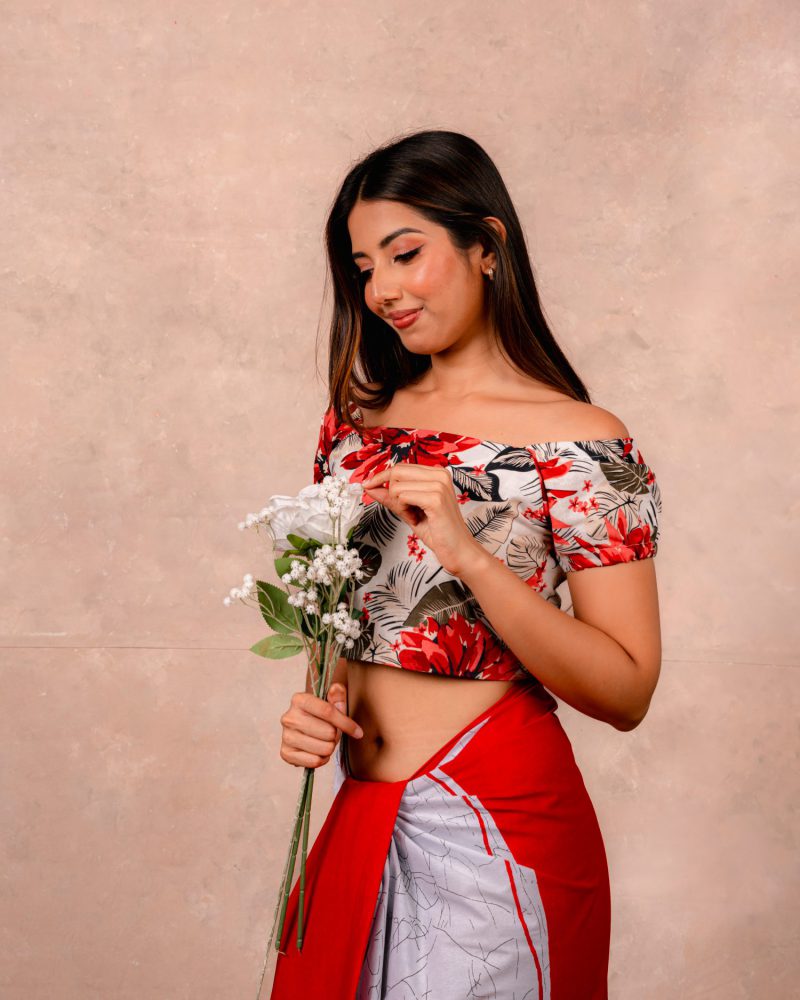 Model holding flowers in a red botanical crop