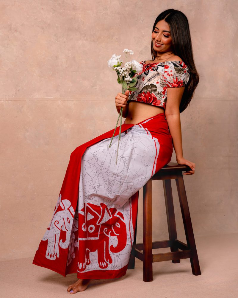Seated model holding wildflowers in a floral crop