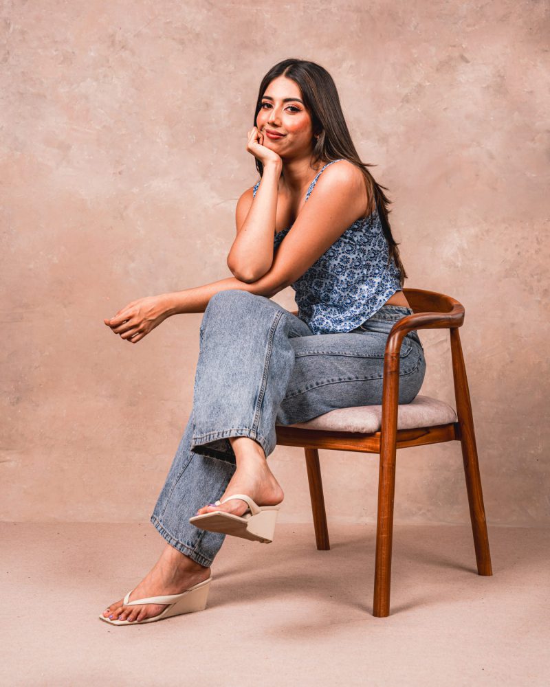 Portrait of a model resting against a studio chair